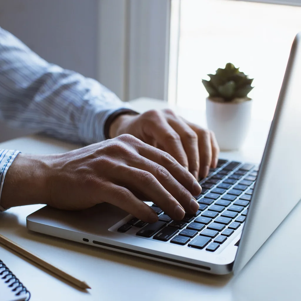 person typing on laptop